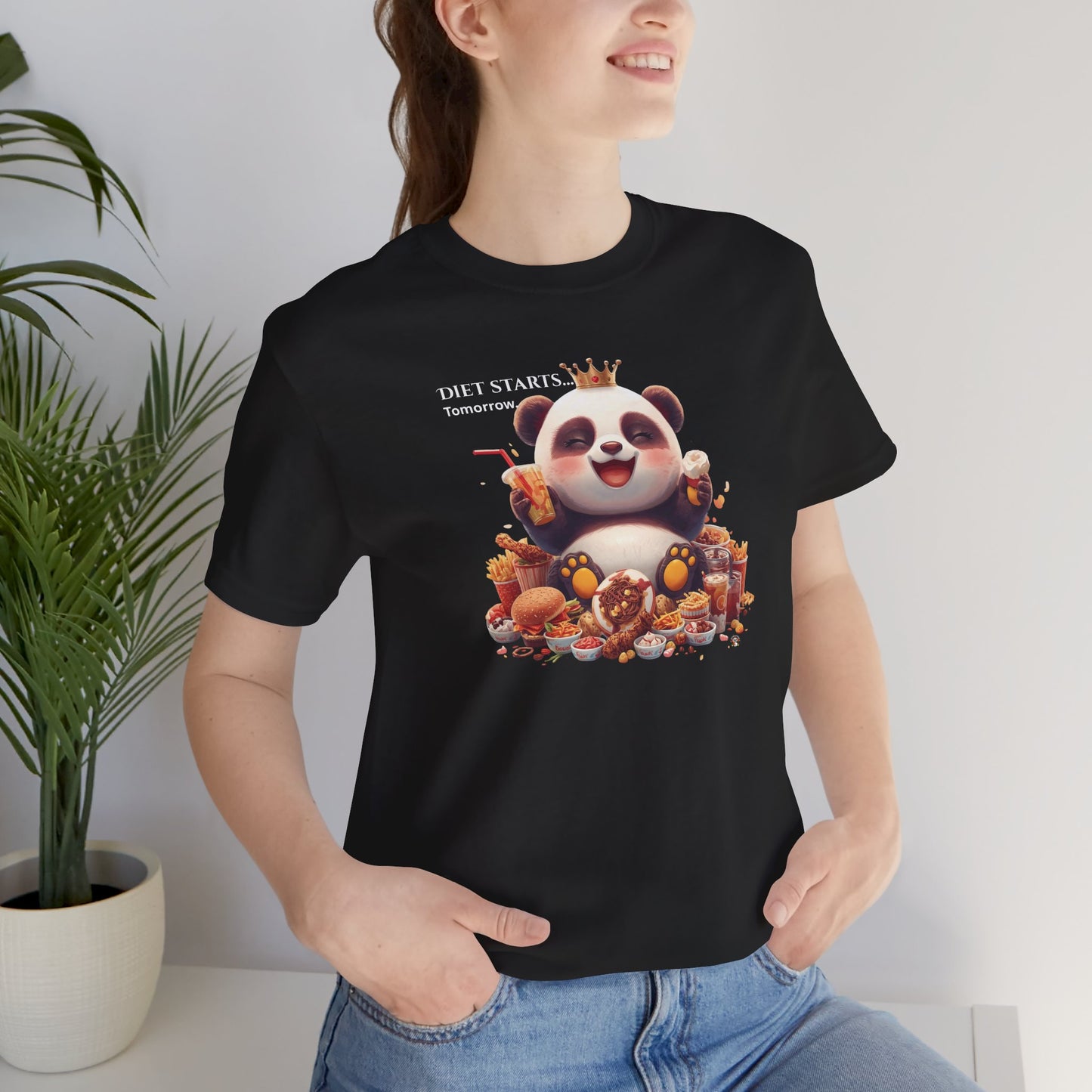 Fat Belly Panda™ “Diet Start Tomorrow” unisex tee for men and women — chubby baby panda happily holding snacks and smiling, playful Too Cute to Behave design on black background.